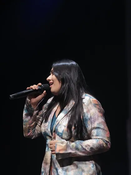 A side profile shot during my performance. The stage lights and the energy of the crowd make for an unforgettable experience.