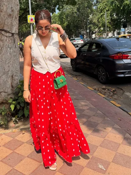 This outfit from my Janpath shopping trip is a great example of mixing high and low. The vibrant red skirt is a market find, paired with a classic white waistcoat and a pop of color with the green bag.