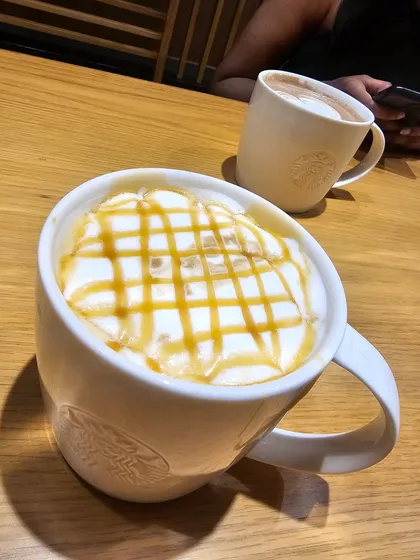 A delicious caramel macchiato from Starbucks, topped with whipped cream and caramel drizzle. It's the perfect sweet treat to fuel the rest of your journey.