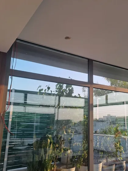 An interior perspective showing the junction between the solid ceiling of the house and the new glass roof of the sunroom. We ensure every detail is finished cleanly for a professional and integrated look.