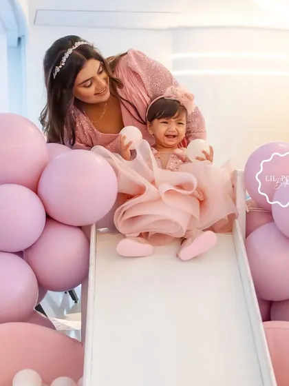 A precious moment captured as the birthday girl, Aahana, enjoys the slide in her custom pink ball pit.