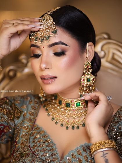 A close-up of a high-definition bridal makeup look from a professional shoot. The focus is on the intricate eye makeup and the flawless, glowing skin, perfect for magazine-quality photos.
