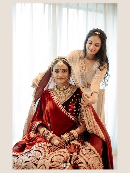 A tender moment between the bride and her bridesmaid, who helps her with the veil. A beautiful capture of friendship on the wedding day.