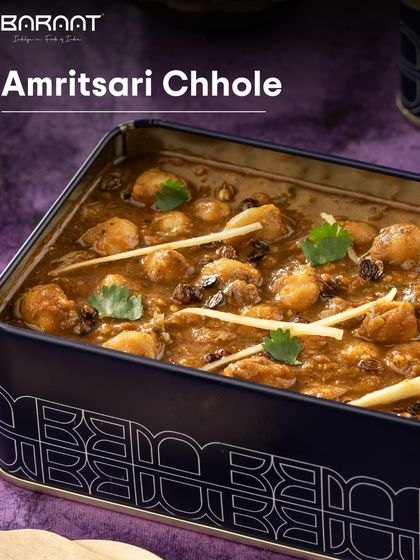A close-up of our Amritsari Chhole, served in our stylish tin box, showcasing the rich gravy and perfectly cooked chickpeas.