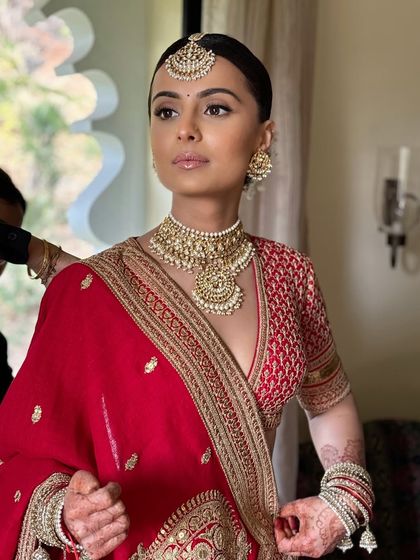 The bride looks powerful and poised. The soft glam makeup enhances her strong features beautifully.