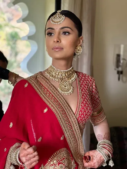 The bride looks powerful and poised. The soft glam makeup enhances her strong features beautifully.