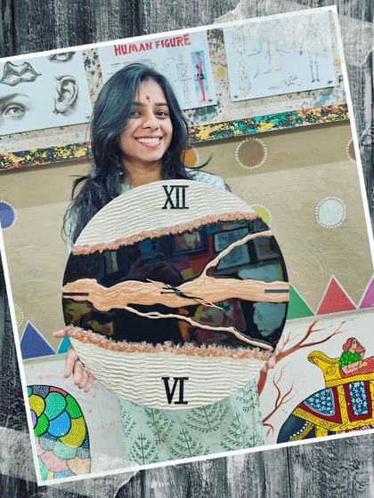 A student proudly holds her unique resin clock, featuring a textured, earthy design that combines modern art with rustic charm.