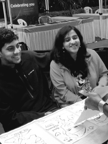 A candid shot of a couple enjoying the moment their caricature is revealed. These happy faces make every event special.