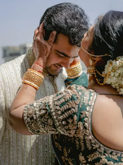 A mother's gentle touch. A candid, emotional moment between the groom and his mother on his wedding day.