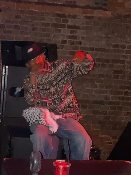 A shot of me getting into the groove during a set. I often end up on top of the speakers. It's all about feeling the music and having a good time.