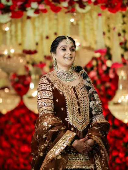 A joyful moment captured. Her smile radiates pure happiness, and the makeup enhances her features with a soft glam that is both elegant and celebratory, perfect for a wedding reception.