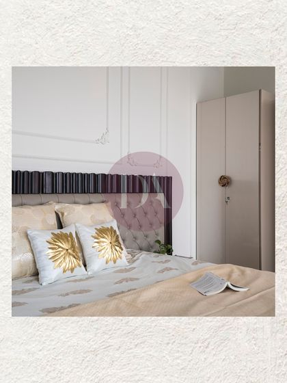 A detail shot of the bedside, highlighting the custom headboard with both tufted and fluted details. The gold and white embroidered cushions add a touch of luxury and texture.
