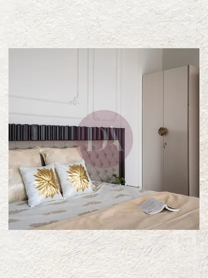 A detail shot of the bedside, highlighting the custom headboard with both tufted and fluted details. The gold and white embroidered cushions add a touch of luxury and texture.