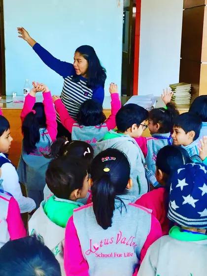 Here, during a session at a local school, I'm guiding the children through a new movement. My classes are designed to be interactive and fun, helping kids build body awareness and learn to manage their energy in a positive, healthy way.