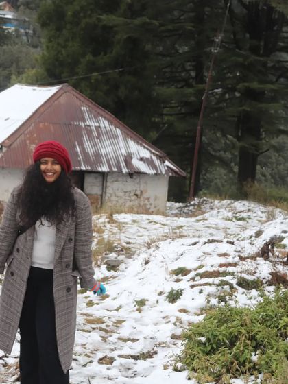 Enjoying the snow in Uttarakhand. My winter outfit was all about staying warm without sacrificing style, combining a classic coat with fun, colorful accessories.