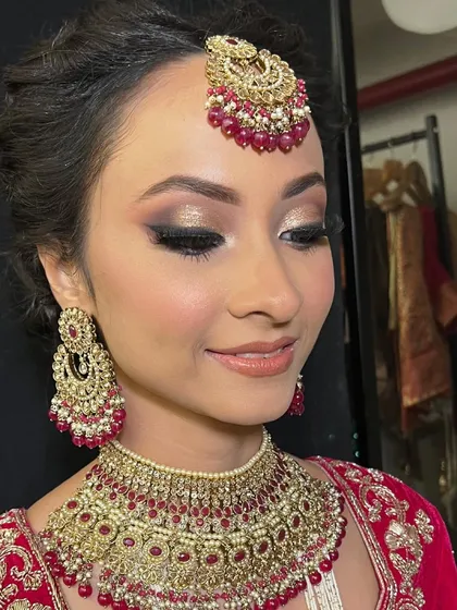 Another angle of this glamorous bridal look, highlighting the flawless skin and the beautiful contrast of the dark liner with the gold shadow.
