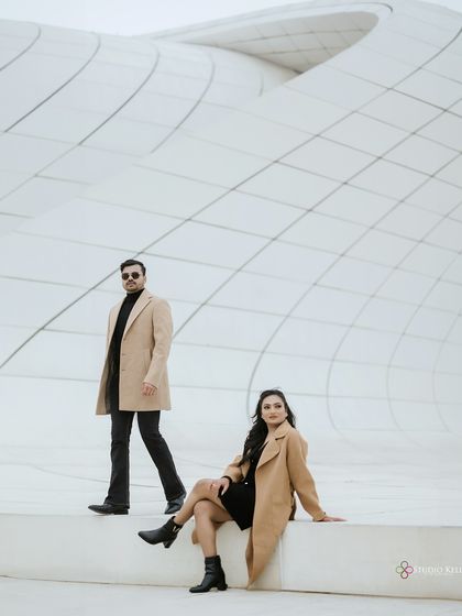 A stylish, posed shot against the geometric patterns of a modern building in Baku. The composition emphasizes clean lines and a contemporary, chic vibe for this pre-wedding shoot.