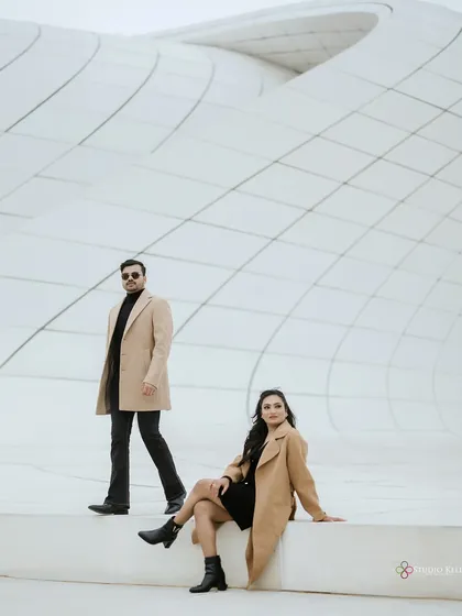 A stylish, posed shot against the geometric patterns of a modern building in Baku. The composition emphasizes clean lines and a contemporary, chic vibe for this pre-wedding shoot.