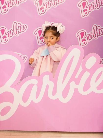 A little guest enjoying the Barbie-themed photo booth. Our interactive setups are designed to be fun for kids and provide perfect, shareable moments for parents.