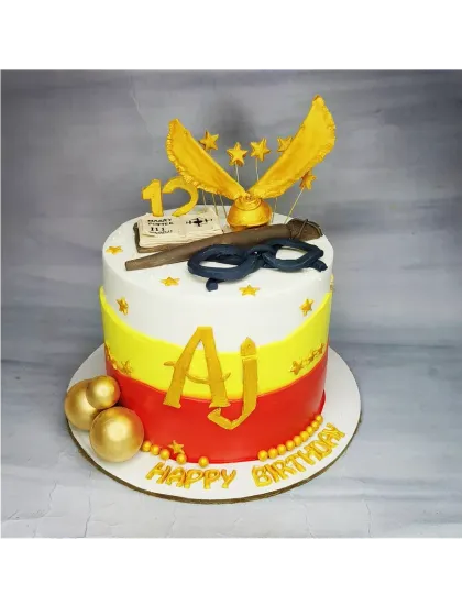 A 2kg Harry Potter cake with a fresh pineapple flavor. This design features the Gryffindor colors and is topped with a golden snitch and wand.