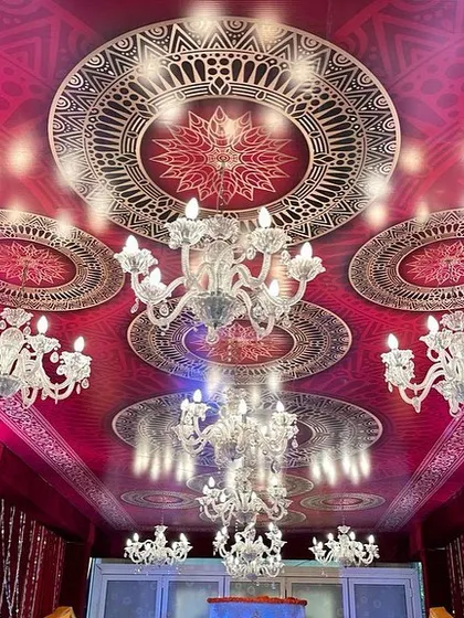 The ceiling detail from one of our grand religious event setups. We used rich red fabric and intricate printed mandalas, punctuated by multiple crystal chandeliers to create a feeling of opulence and grandeur.