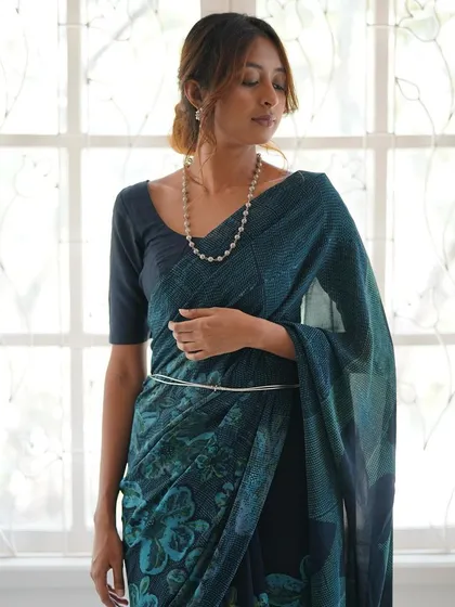 This is our hero item. The Nilā saree embodies our craft. It is a deep indigo silk georgette piece that took over 60 hours to create, combining intricate textures and custom-carved floral motifs using a specialized discharge printing technique.