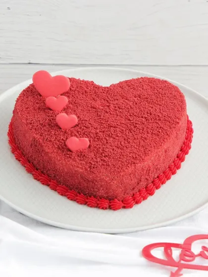 A classic heart-shaped red velvet cake, perfect for Valentine's Day or any romantic celebration.