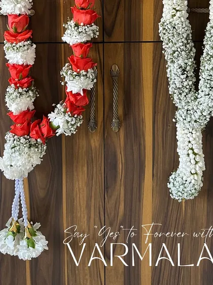 The exchange of garlands is a pivotal moment in an Indian wedding. I design varmalas using both fresh and fabric flowers, like these stunning red rose and baby's breath garlands, to symbolize your union beautifully.