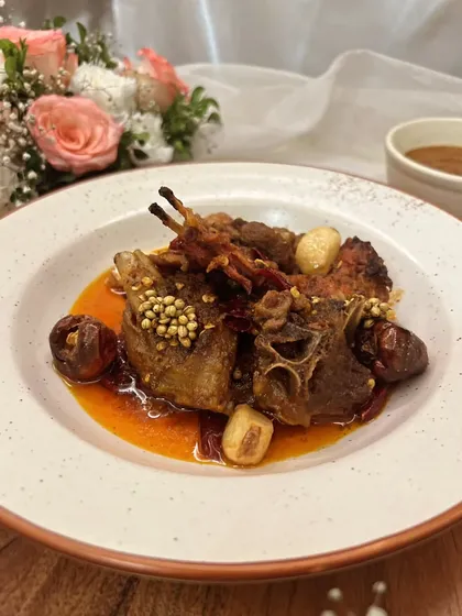 For the true meat lover, I present the Rajasthani Junglee Maas. This is a rustic and spicy dry lamb dish, slow-cooked in A2 cow ghee with confit garlic and boriya chili for a deep, authentic flavor.
