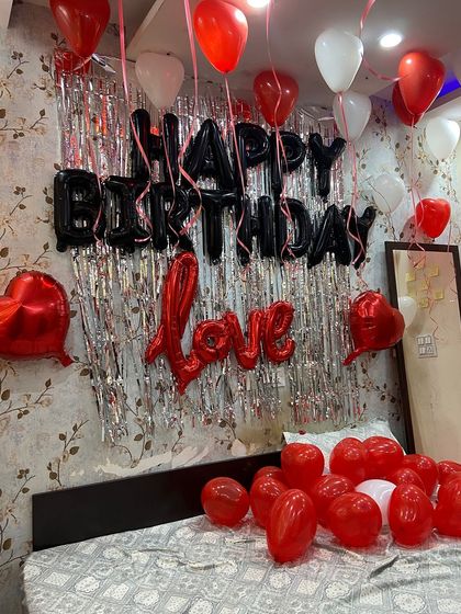 A closer look at the balloon arrangement against the silver fringe backdrop. I use high-quality foil balloons for messages like 'Happy Birthday' and 'Love' to ensure they look great throughout your celebration.