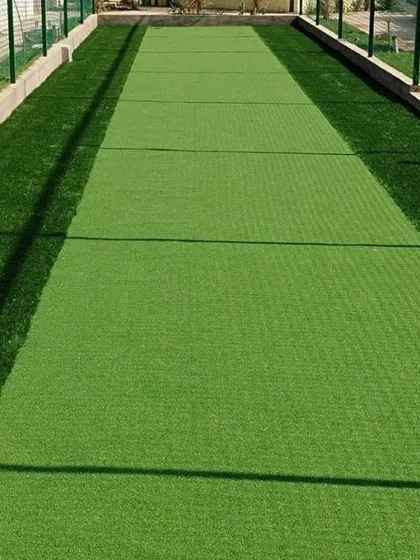 Our expertise extends to specialized sports surfaces like this artificial cricket pitch. We install durable, low-maintenance turf that provides a consistent bounce, making it an ideal solution for cricket practice nets and grounds.