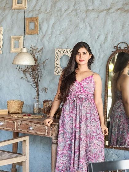 A collection of relaxed, bohemian-style portraits taken at a rustic cafe. The model is featured in a flowing paisley dress, interacting with props like a guitar, creating a natural and artistic vibe.