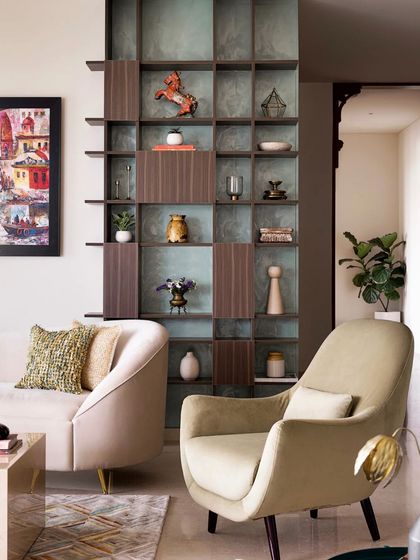This shot shows the open-closed shelving unit that acts as a partition and display case, connecting the foyer to the main living area.