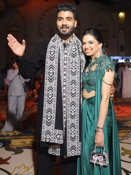 A happy couple shot from the Sufi night. Her green gown complements his classic black kurta, showing how I can help style couples for a coordinated look.