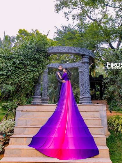 A dramatic shot of a flowing purple and pink gown at our stone gazebo.