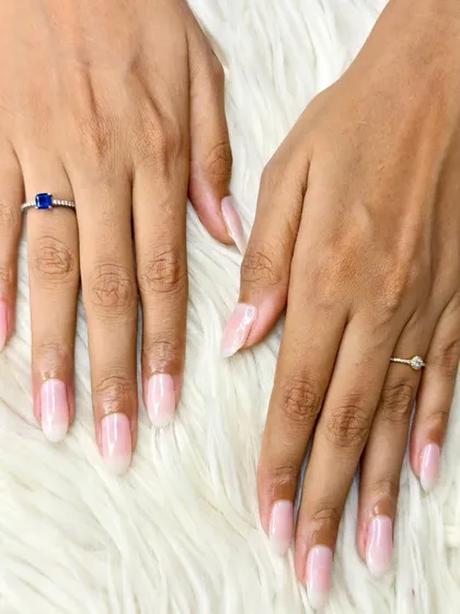 A beautiful set of long, oval-shaped extensions with a natural, milky-white polish for a clean and sophisticated finish.