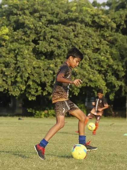 Sweat it out. A player works on his ball control during a warm summer evening session.