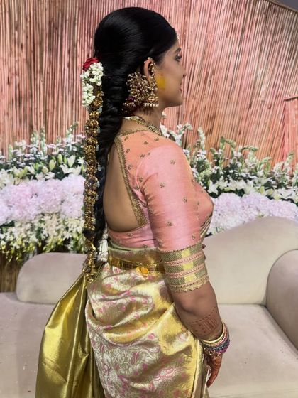 Another side view of Akanksha's engagement look, showing her traditional hairstyle and the elegant drape of her saree.