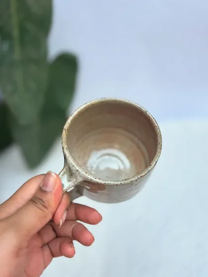 A look inside the Shino cup, showing the smooth, glossy interior and the throwing rings that mark it as handmade.