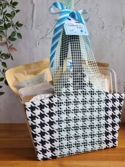 A stylish houndstooth pattern basket filled with our snacks, a chic and modern gift option for Father's Day.