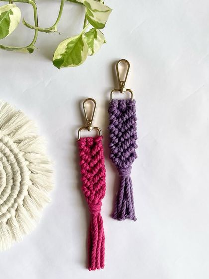 A simple and elegant macrame keychain design, shown here in pink and purple. These are great for bridesmaid gifts or party favors.