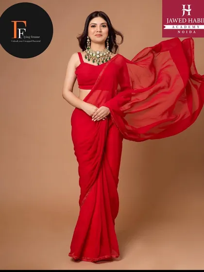 Another beautiful shot of the model in the red saree, showcasing the elegant makeup and hair done by our students.