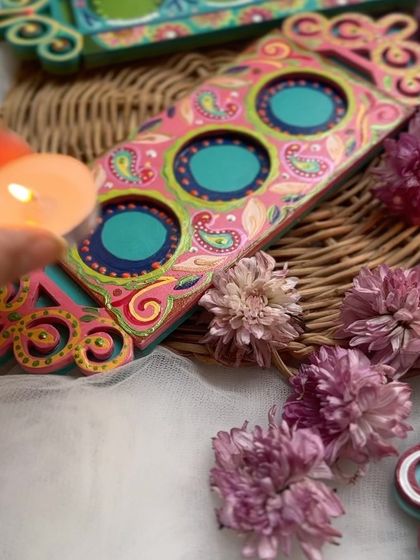 A close up of our paisley and floral themed tea light holder. The intricate details and vibrant colors make it a stunning decorative piece.