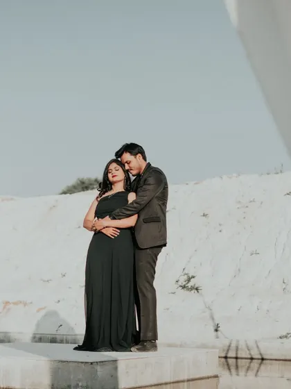A quiet, intimate embrace in the minimalist landscape. The simplicity of the background puts all the focus on the couple's connection.