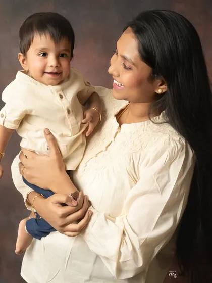 A mother holding her little boy, sharing a look of pure adoration. This candid shot captures the sweet, everyday interactions that define the mother-son bond.