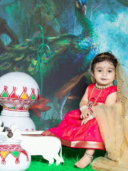 A sweet and innocent portrait of a baby girl dressed as Radha.