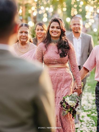 The bride, Ameera, being walked down the aisle by her father. The groom's reaction in the foreground adds another layer of emotion to this powerful moment.