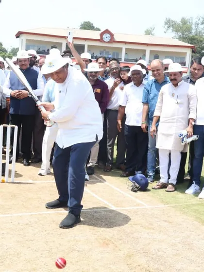 Another dignitary trying his hand at batting, celebrating the launch of our new cricket center.