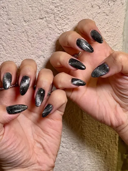 Dark, magnetic, and unforgettable. This black cat-eye set on almond-shaped extensions has a galactic, starry-night vibe that is absolutely captivating.