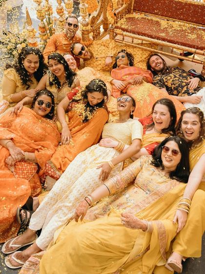 A beautiful mess of flowers and laughter. This overhead shot of the bride and her friends during the Haldi ceremony is a vibrant tableau of joy and friendship.